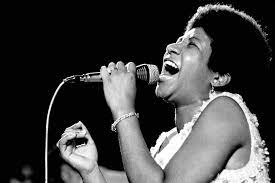 Black and white photo of Aretha Franklin singing